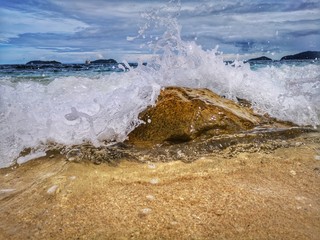Closeup with the sandy beach splashing water and swash wave in Kota Kinabalu, Tanjung Aru beach....
