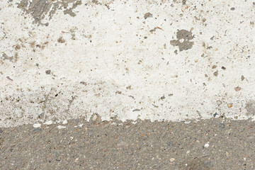 Old asphalt surface with white paint on it close up. Abstract background	