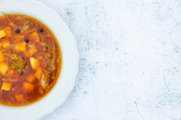 Borscht - homemade Ukrainian or Russian traditional soup. Soup with beetroot, cabbage, potato. Top above view. Space for text