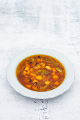 Borscht - homemade Ukrainian or Russian traditional soup. Soup with beetroot, cabbage, potato. Top above view. Space for text