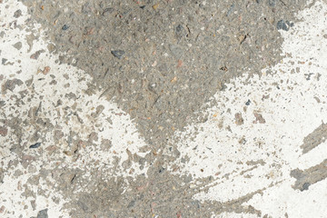 Old asphalt surface with white paint on it close up. Abstract background