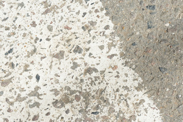 Old asphalt surface with white paint on it close up. Abstract background