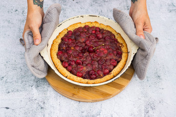 Tasty homemade cherry baked tart, pie or cake with berries.