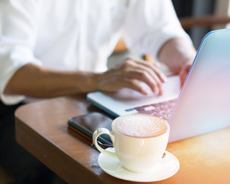 Causal professional Business man using multichannel services with internet wifi 5G on smartphone and online tablet in coffee shop.City lifestyle businessman hands working using mobile phone concept