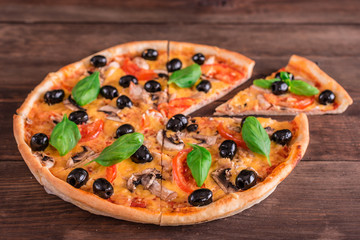 Tasty fresh hot pizza against a dark background. Pizza, food, vegetable, mushrooms