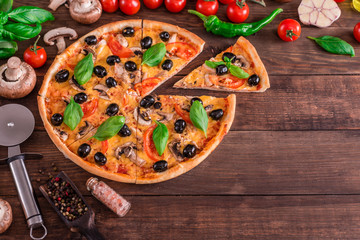 Tasty fresh hot pizza against a dark background. Pizza, food, vegetable, mushrooms