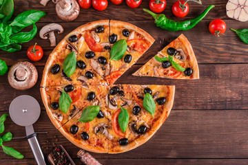 Tasty fresh hot pizza against a dark background. Pizza, food, vegetable, mushrooms