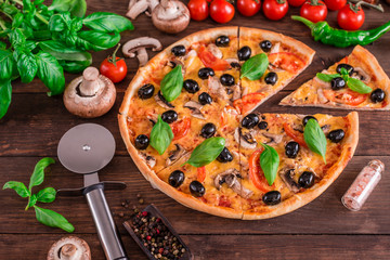 Tasty fresh hot pizza against a dark background. Pizza, food, vegetable, mushrooms