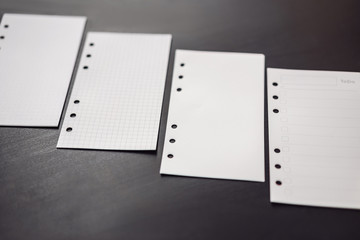 Different paper for notepad mocap on a black wooden background