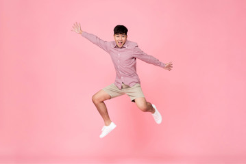 Fototapeta na wymiar Energetic happy young Asian man jumping