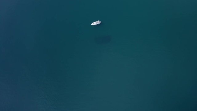 Aerial Shot of Boat Floating on Clear, Calm, Blue Water on Sunny Day Batiliman, Black sea, Crimea