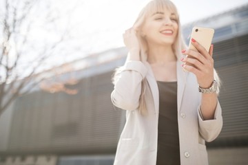 Portrait of a young girl holding a mobile phone.