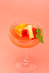 Colorful fruit punch cocktail drink in coupe glass