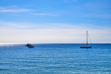 Obraz premium View to the sea, blue sky, white clouds and ships on a Sunny day