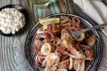 Fried calamari on a wooden table