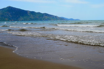 Fototapeta na wymiar waves on the Mediterranean Sea on the shore of a turtle island in Dalyan, Turkey