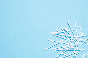 Cotton buds on a blue background. Concept of makeup, personal hygiene. Flat lay, top view