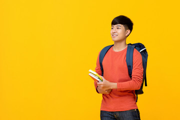 Asian male college student with backpack holding books