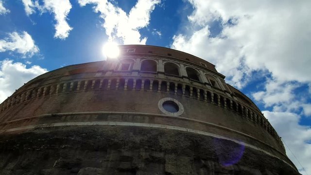 Castle Sant Angelo or Mausoleum, in Rome, Italy, against the blue sky.The sun's rays look from the castle. View from the foot of the castle uphill.