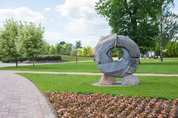 City Jelgava, Latvian Republic. City park with sculpture and flowers. Walking paths and trees. Jun 9. 2019. Travel photo.