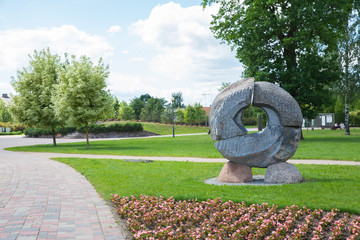City Jelgava, Latvian Republic. City park with sculpture and flowers. Walking paths and trees. Jun 9. 2019. Travel photo.