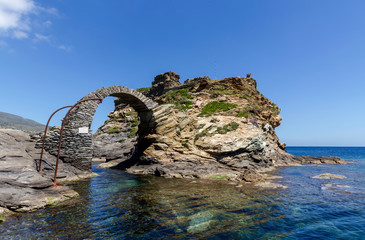 Fototapeta premium Fragment of the Kastro fortress and arched bridge on Andros Island (Greece, Cyclades)