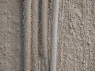 Fototapeta premium Cabling running down the side of a building image with copy space