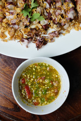 Squid Fried garlic and Seafood sauce in white dish, wood background