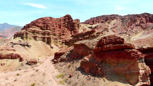 Colored rocks around Salta, Argentina. Flying over red rock formation in Southern Andes mountains. Aerial shot, 4K