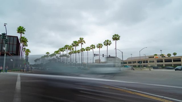 Time lapse of a busy intersection with blurred cars driving by.