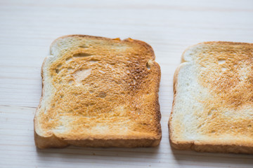 Crispy gold baked toast slices on a wooden table.