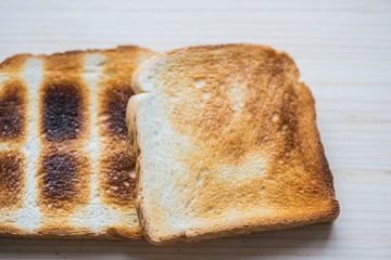 Crispy gold baked toast slices on a wooden table.
