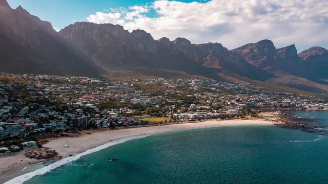 Aerial view of coastal Clifton in Cape Town, South Africa on a sunny morning with the ocean and beach below.