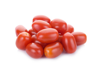 Falling plum tomatoes isolated on white background