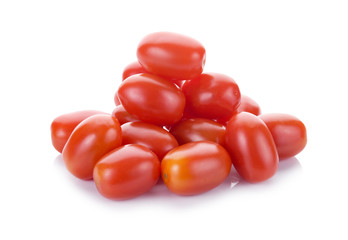 Falling plum tomatoes isolated on white background