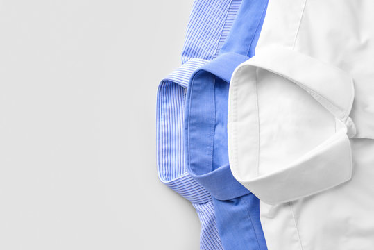 Shirts after dry-cleaning on light background