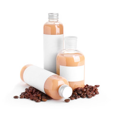 Bottles of shampoo and coffee beans on white background