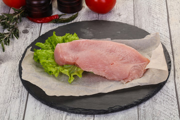 Raw Turkey steak served rosemary