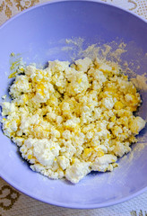 Cheesecake kneading, cottage cheese in bowl, flour, sugar and eggs. 