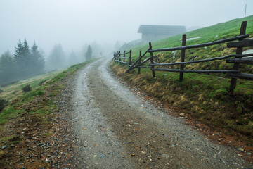 Fototapeta na wymiar The Dolomites. The fenced path in the mountain hills.