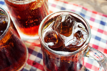 Close up glass of cola with ice.