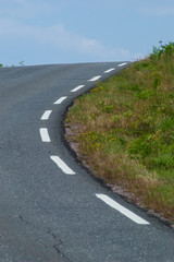 A curvy road over a crest.