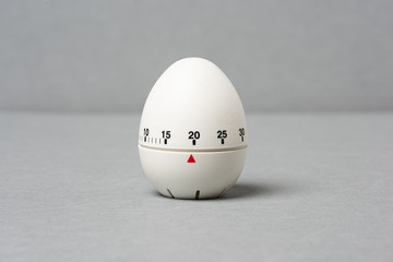 Egg timer  on grey background. - obrazy, fototapety, plakaty