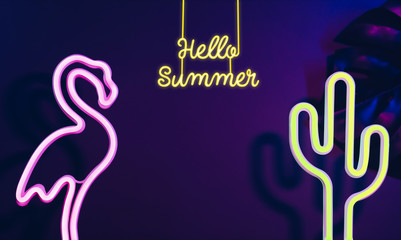 Hello Summer with pink flamingo, cactus and monstera leaf with neon pink and blue light.Vacation...