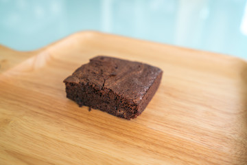 Chocolate brownies on wooden surface