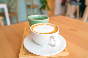 Hot coffee on wooden table