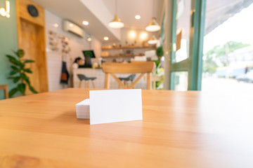 Blank business cards on wooden surface