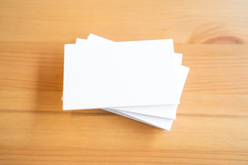 Blank business cards on wooden surface
