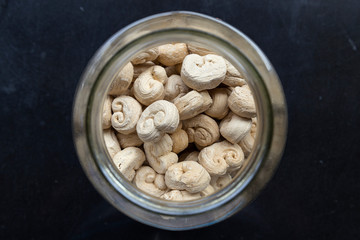 Organic natural candies in jar on black background
