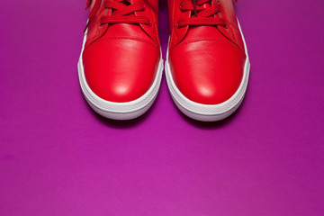 One sport red sneakers on purple background